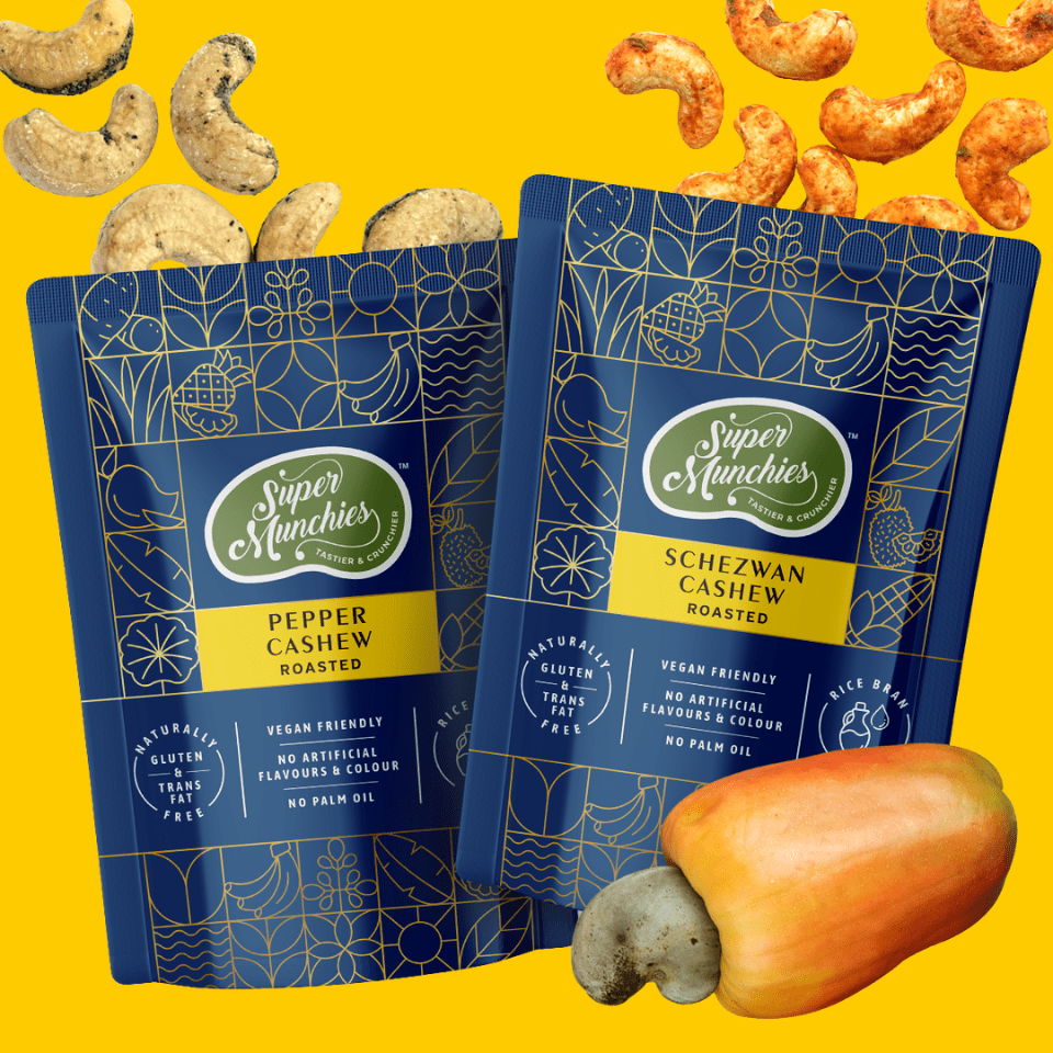 Two packages of Super Munchies cashew snacks on a yellow background with cashews and a cashew nut.