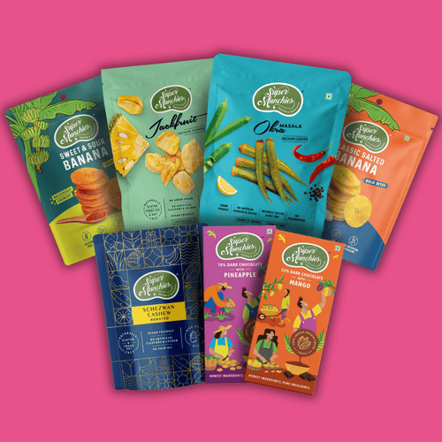 Assorted Super Munchies packages on a pink background
