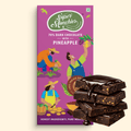 Super Munchies 70% dark chocolate with pineapple packaging and chocolate bars on a beige background