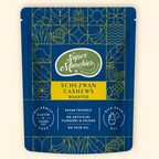 Super Munchies Schezwan Cashews packaging on a beige background
