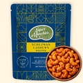 Super Munchies Schezwan Cashews packaging with a bowl of schezwan cashews on a beige background